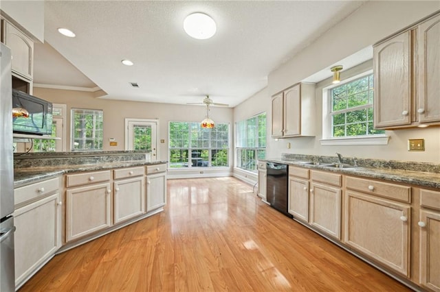 4761 Sharp Rd, Mandeville, LA 70471 - kitchen featuring black appliances, light wood-type flooring, light brown cabinets, dark countertops, and a textured ceiling