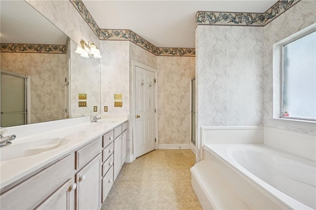 4761 Sharp Rd, Mandeville, LA 70471 - full bathroom with a garden tub, healthy amount of natural light, double vanity, and a shower stall