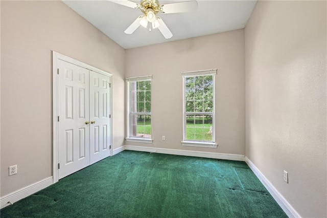 4761 Sharp Rd, Mandeville, LA 70471 - unfurnished bedroom with dark colored carpet, a closet, and a ceiling fan