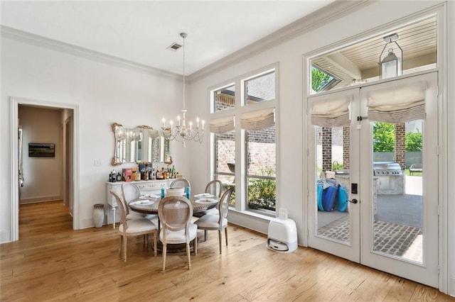 sunroom / solarium with a notable chandelier, french doors, and visible vents