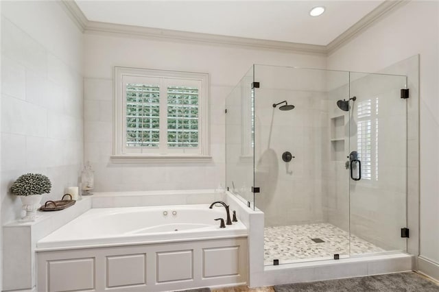 bathroom featuring a shower stall, a garden tub, and crown molding