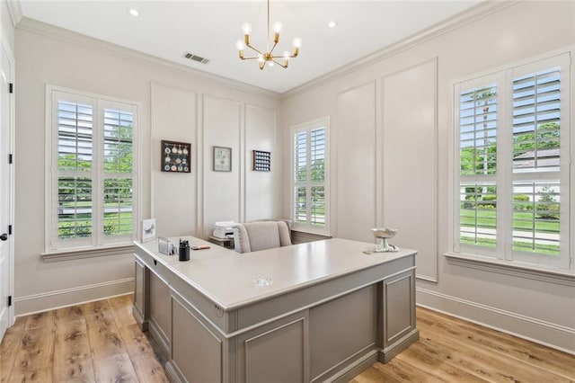 office with a chandelier, ornamental molding, a wealth of natural light, and light wood finished floors