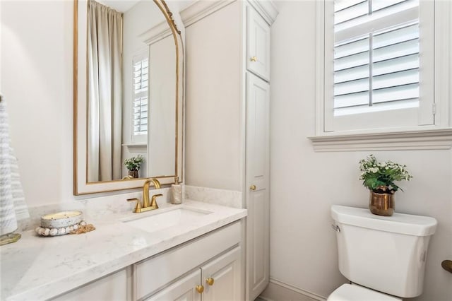 bathroom featuring toilet and vanity