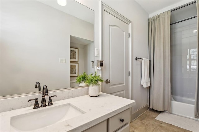 bathroom with shower / bath combo, vanity, and baseboards