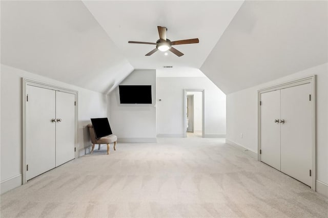 bonus room with light colored carpet, ceiling fan, visible vents, and vaulted ceiling