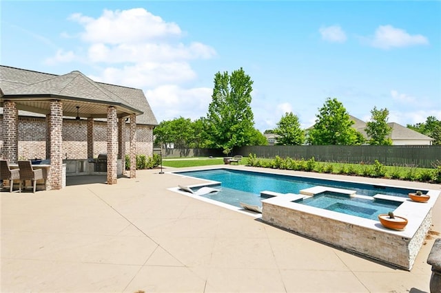 view of pool featuring an outdoor bar, a patio area, a pool with connected hot tub, and a fenced backyard