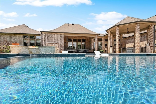 community pool featuring outdoor lounge area, a ceiling fan, area for grilling, and a patio