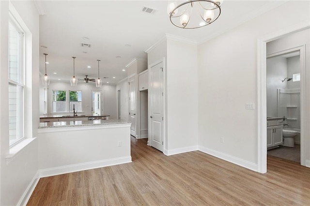 unfurnished living room featuring recessed lighting, light wood-style flooring, ornamental molding, baseboards, and visible vents