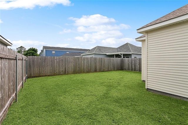 view of yard with a fenced backyard