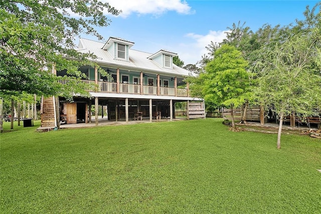 rear view of house featuring stairway and a lawn