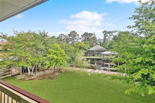 view of yard featuring a water view and a boat dock
