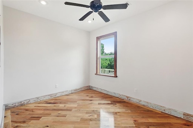 unfurnished room featuring recessed lighting, light wood-type flooring, a ceiling fan, and baseboards