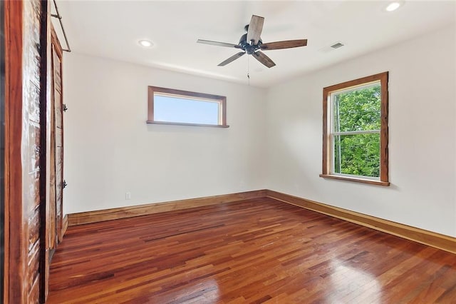 unfurnished room with visible vents, baseboards, wood finished floors, and recessed lighting