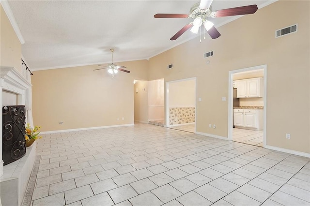 unfurnished living room with ceiling fan, ornamental molding, baseboards, high vaulted ceiling, and light tile patterned flooring