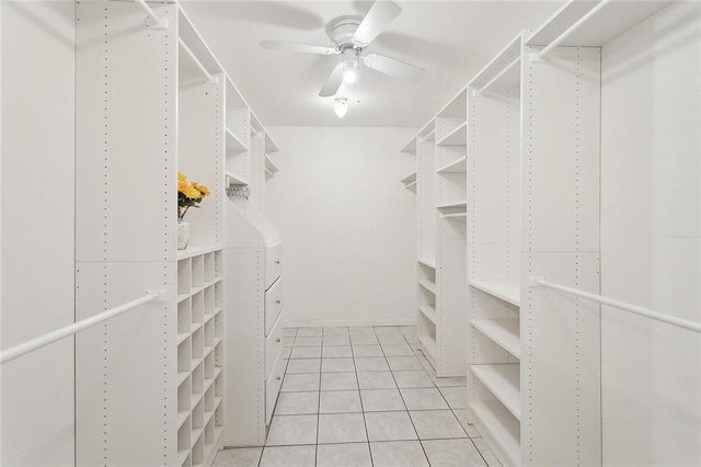 spacious closet featuring light tile patterned flooring and a ceiling fan