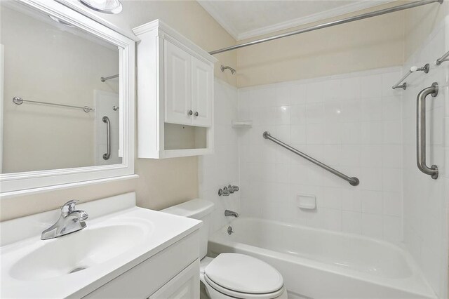 bathroom featuring toilet, vanity, crown molding, and washtub / shower combination