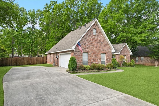 exterior space featuring fence, driveway, a lawn, brick siding, and a garage