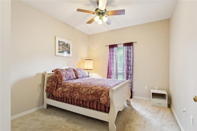bedroom featuring a ceiling fan, baseboards, and carpet