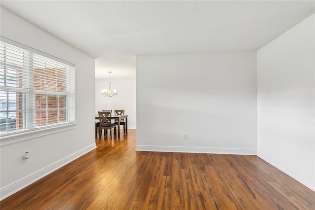 2121 Mediamolle Dr, New Orleans, LA 70114 - unfurnished room featuring a chandelier, wood finished floors, and baseboards