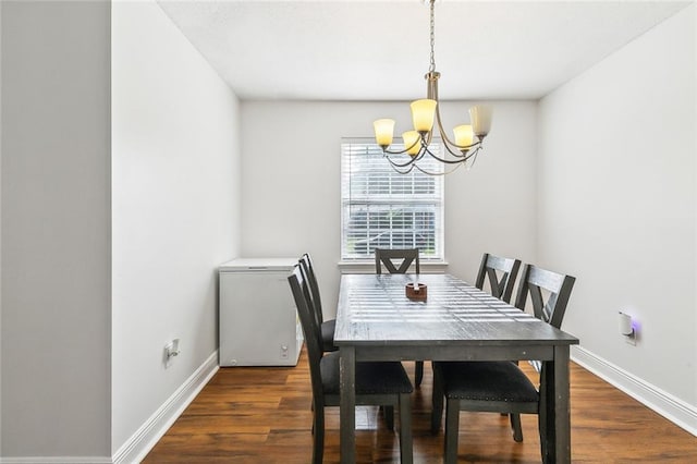 2121 Mediamolle Dr, New Orleans, LA 70114 - dining room featuring a chandelier, baseboards, and wood finished floors