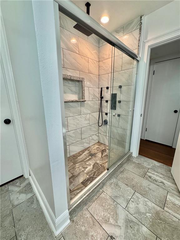 2121 Mediamolle Dr, New Orleans, LA 70114 - full bath with stone tile floors, a stall shower, and recessed lighting