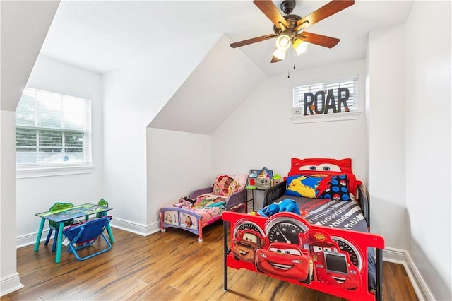 2121 Mediamolle Dr, New Orleans, LA 70114 - bedroom with multiple windows, wood finished floors, baseboards, ceiling fan, and vaulted ceiling