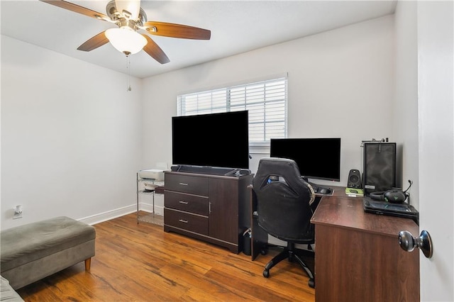 2121 Mediamolle Dr, New Orleans, LA 70114 - home office with wood finished floors, a ceiling fan, and baseboards