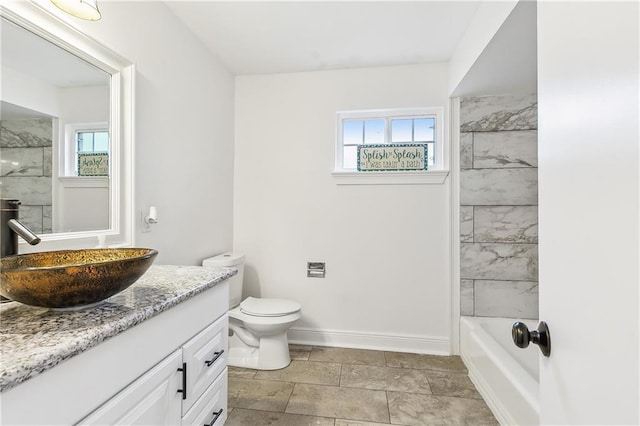 2121 Mediamolle Dr, New Orleans, LA 70114 - bathroom with plenty of natural light, vanity, toilet, and baseboards