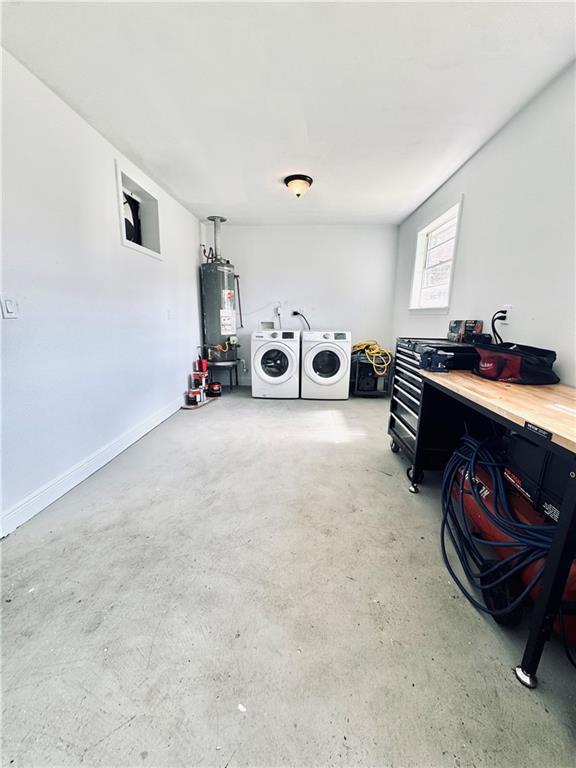 2121 Mediamolle Dr, New Orleans, LA 70114 - laundry room with water heater, washing machine and clothes dryer, and baseboards
