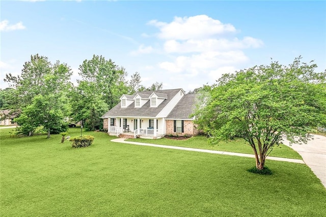 1229 Hampton Ct, Slidell, LA 70460 - cape cod-style house featuring brick siding, a front yard, and covered porch