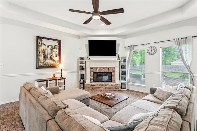 1229 Hampton Ct, Slidell, LA 70460 - living area with carpet, ceiling fan, a raised ceiling, baseboards, and a brick fireplace