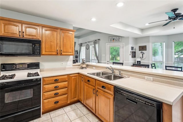 1229 Hampton Ct, Slidell, LA 70460 - kitchen featuring a peninsula, a sink, black appliances, light countertops, and light tile patterned floors