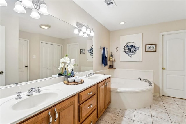 1229 Hampton Ct, Slidell, LA 70460 - bathroom featuring double vanity, visible vents, a garden tub, and a sink