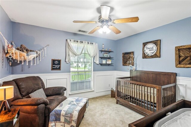1229 Hampton Ct, Slidell, LA 70460 - bedroom with a ceiling fan, a wainscoted wall, visible vents, and carpet