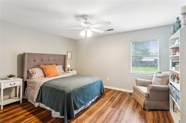 1229 Hampton Ct, Slidell, LA 70460 - bedroom with baseboards, wood finished floors, visible vents, and ceiling fan