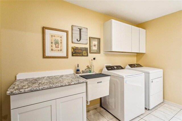 1229 Hampton Ct, Slidell, LA 70460 - clothes washing area with light tile patterned floors, a sink, independent washer and dryer, baseboards, and cabinet space