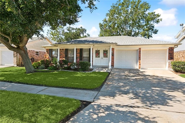ranch-style home featuring a garage, brick siding, a front lawn, and concrete driveway
