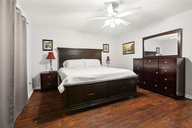 bedroom with a ceiling fan, dark wood-style flooring, and baseboards