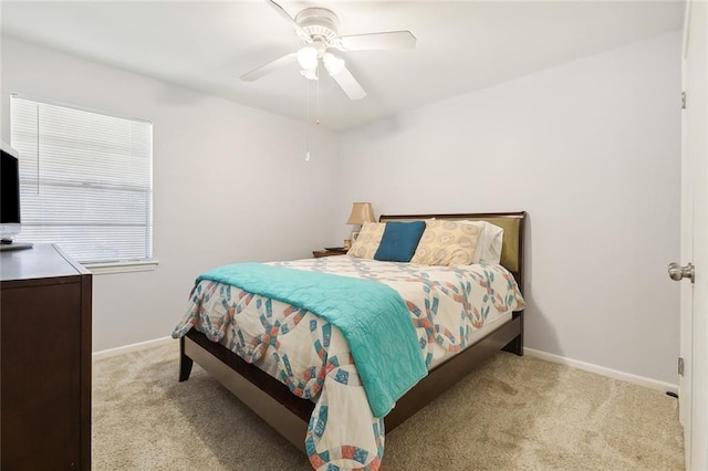 bedroom with baseboards, ceiling fan, and light colored carpet