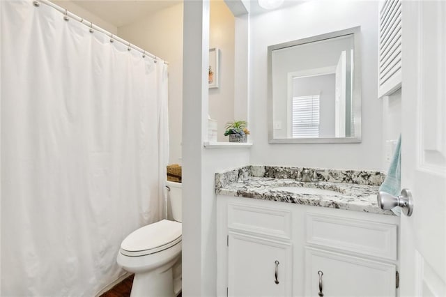 bathroom featuring toilet, a shower with curtain, and vanity