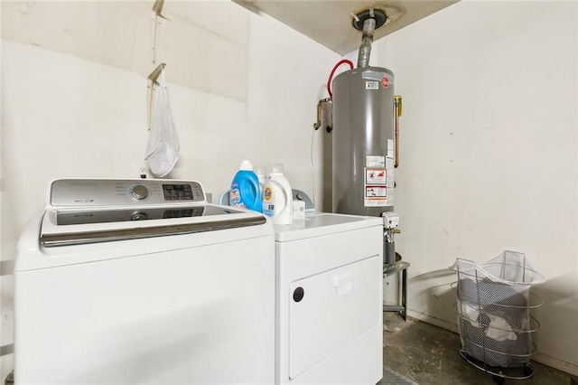 clothes washing area with gas water heater, separate washer and dryer, and laundry area