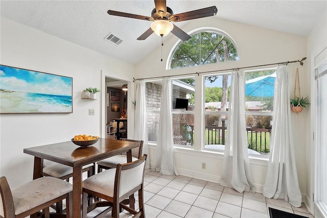 dining room featuring vaulted ceiling, visible vents, a ceiling fan, and a healthy amount of sunlight