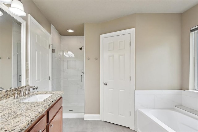 bathroom with a bath, vanity, recessed lighting, and a stall shower