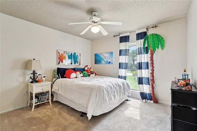 carpeted bedroom featuring baseboards, a ceiling fan, and a textured ceiling
