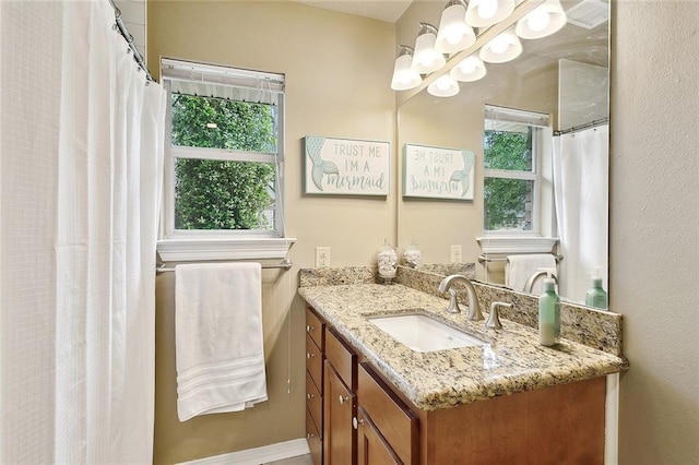 bathroom with baseboards and vanity