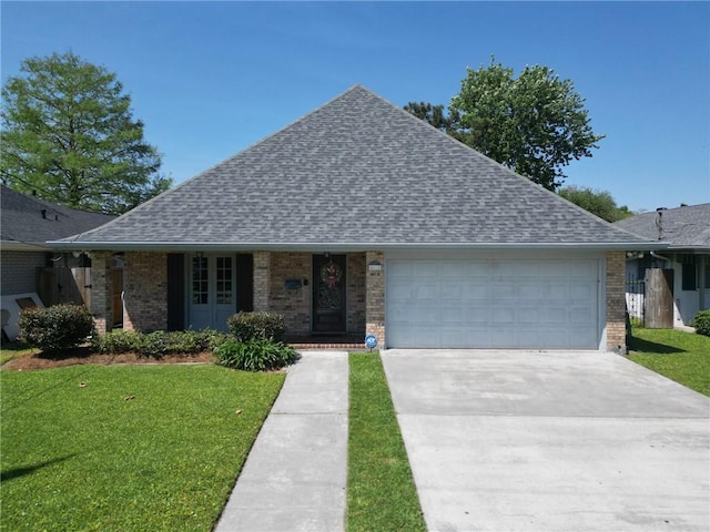 4612 Lorino St, Metairie, LA 70006 - view of front of house featuring an attached garage, roof with shingles, a front yard, and concrete driveway
