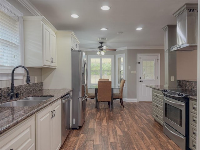 4612 Lorino St, Metairie, LA 70006 - kitchen with wall chimney exhaust hood, stainless steel appliances, a sink, crown molding, and a ceiling fan