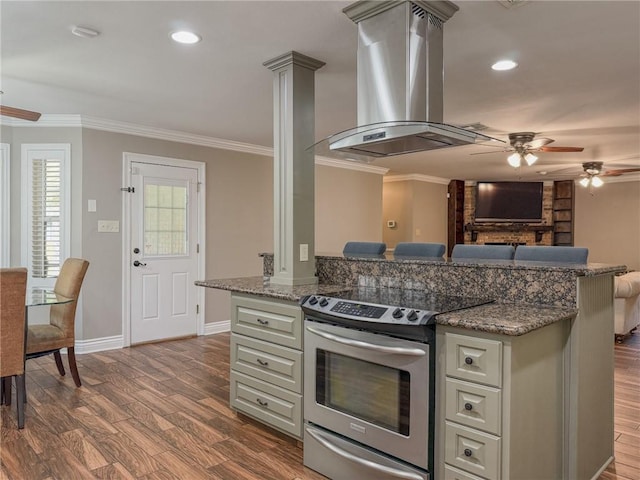 4612 Lorino St, Metairie, LA 70006 - kitchen featuring electric stove, island exhaust hood, ceiling fan, ornamental molding, and dark wood-style floors