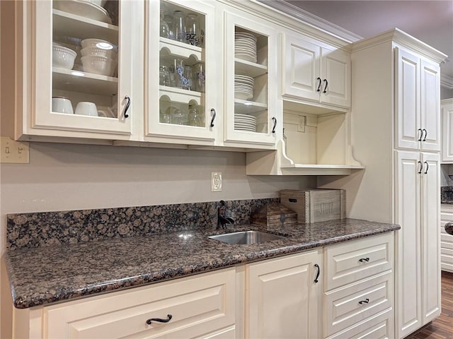 4612 Lorino St, Metairie, LA 70006 - kitchen with a sink, glass insert cabinets, and white cabinetry
