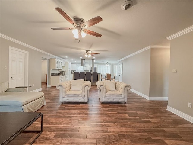 4612 Lorino St, Metairie, LA 70006 - living area with ceiling fan, crown molding, baseboards, dark wood-type flooring, and recessed lighting